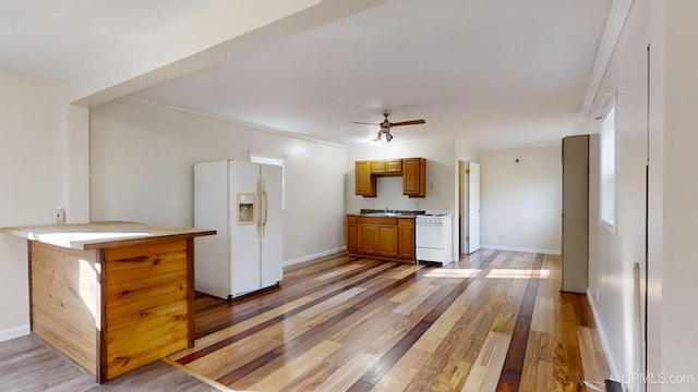 kitchen with white appliances, crown molding, ceiling fan, light wood-type flooring, and kitchen peninsula