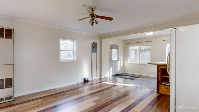 entrance foyer featuring plenty of natural light, ceiling fan, wood-type flooring, and ornamental molding