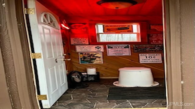 bathroom with wood walls