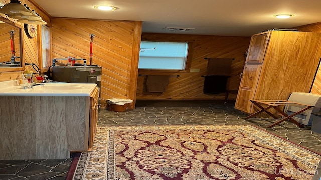 bathroom featuring wood walls and vanity