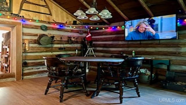 bar featuring hardwood / wood-style floors and lofted ceiling