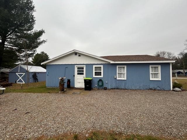 rear view of house featuring an outbuilding