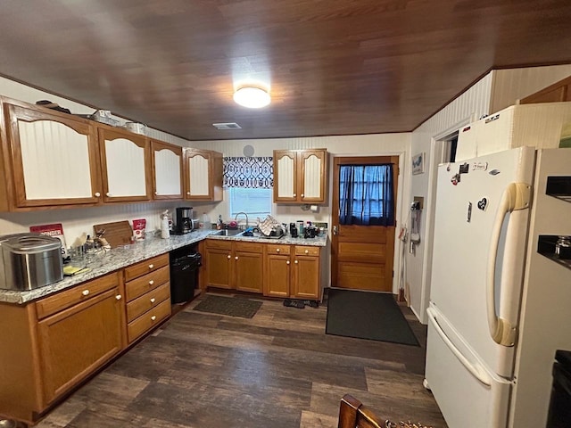 kitchen with dark hardwood / wood-style flooring, light stone counters, sink, white refrigerator, and black dishwasher