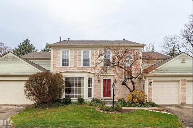 view of front of house with a garage and a front lawn