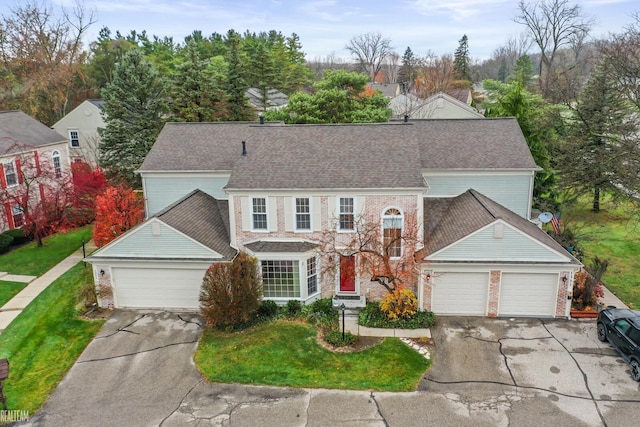 view of front of home with a garage and a front lawn