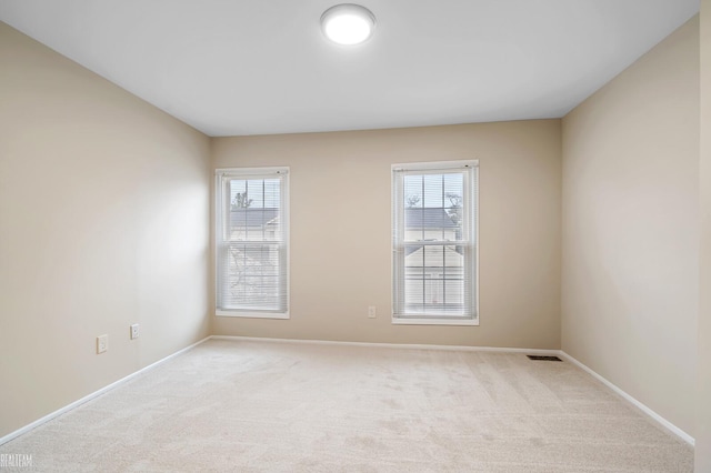 carpeted empty room with a healthy amount of sunlight