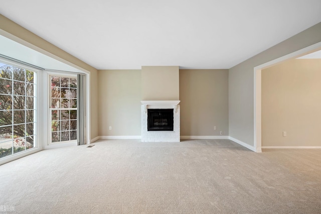 unfurnished living room with a fireplace and light carpet