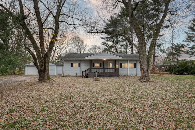 view of front of home with an outbuilding, a garage, and covered porch