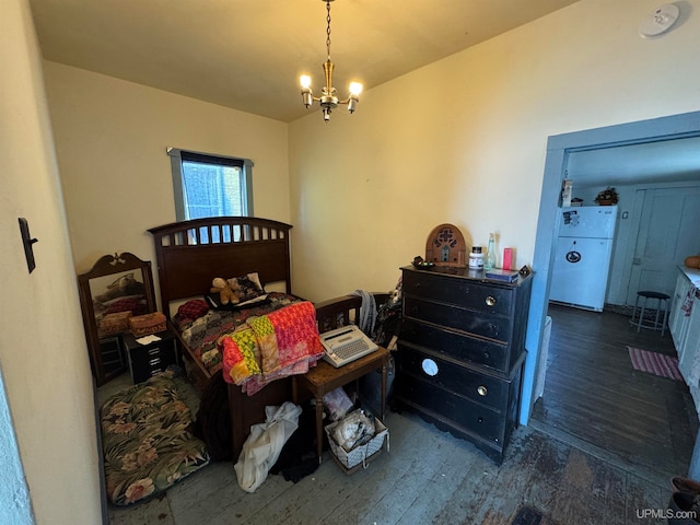 bedroom with a chandelier, dark wood-type flooring, and white refrigerator