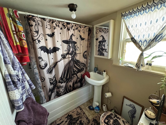 bathroom featuring tile patterned flooring, shower / bathtub combination with curtain, and sink