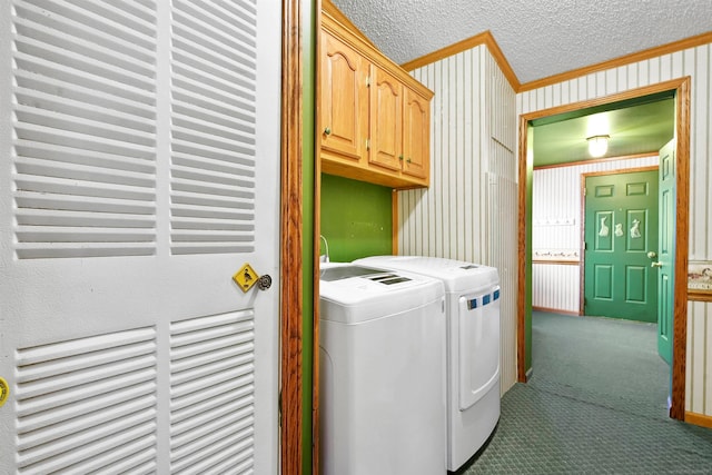 clothes washing area with cabinets, ornamental molding, a textured ceiling, dark colored carpet, and separate washer and dryer