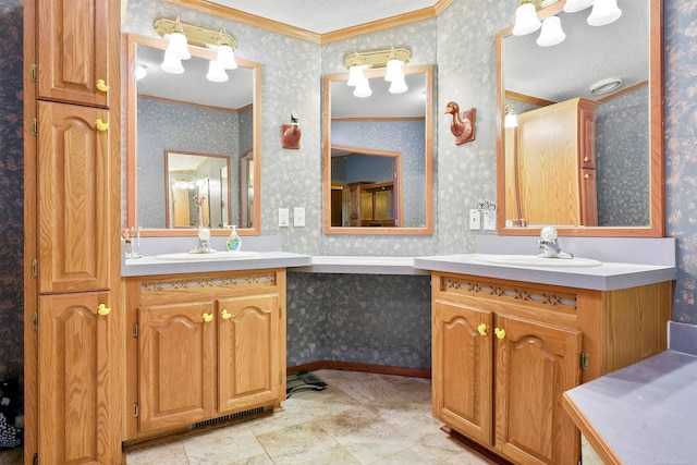 bathroom with vanity, ornamental molding, and a textured ceiling