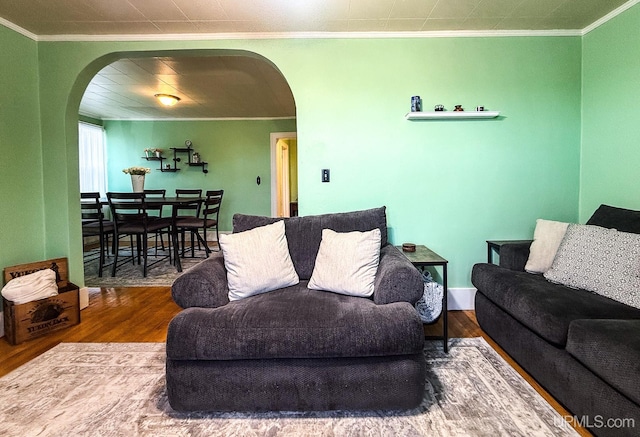 living room with crown molding and hardwood / wood-style flooring