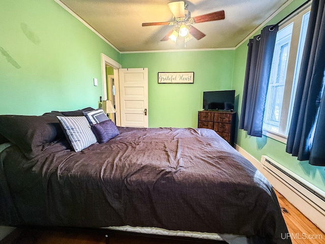 bedroom with hardwood / wood-style floors, ceiling fan, ornamental molding, and baseboard heating