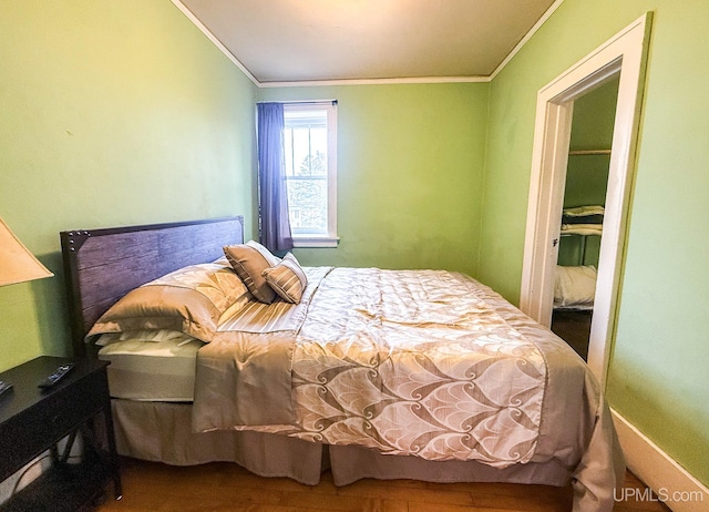 bedroom featuring hardwood / wood-style flooring and ornamental molding