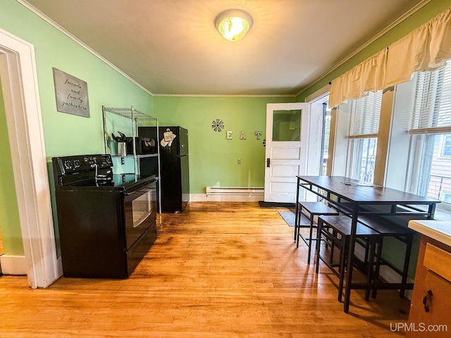 kitchen featuring ornamental molding, light hardwood / wood-style flooring, black appliances, and a baseboard heating unit