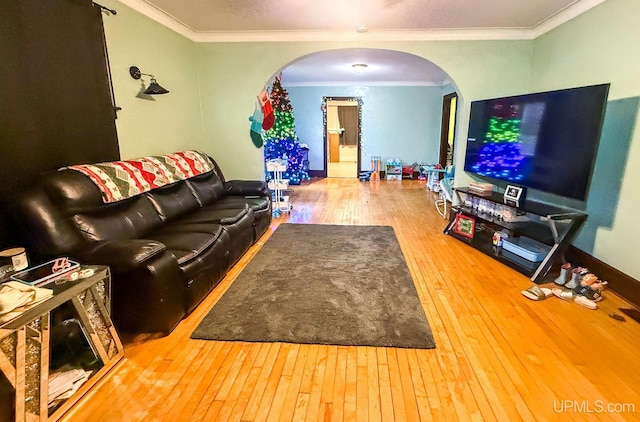 living room featuring hardwood / wood-style flooring and ornamental molding