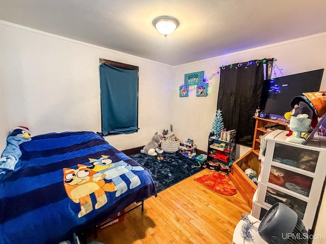 657 Lake Ave, Ironwood, MI 49938 - bedroom with ornamental molding and hardwood / wood-style floors