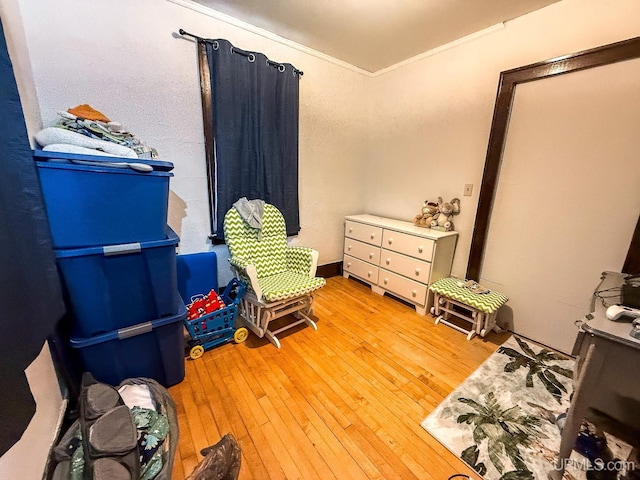 657 Lake Ave, Ironwood, MI 49938 - bedroom with ornamental molding and light wood-style flooring