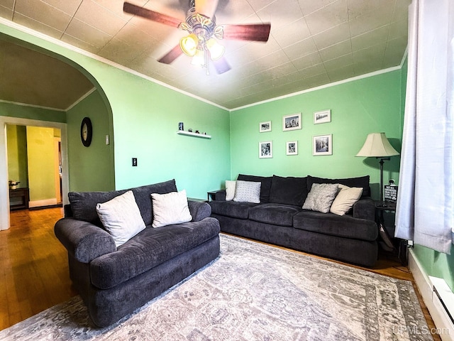 living room with wood-type flooring, a baseboard heating unit, crown molding, and ceiling fan