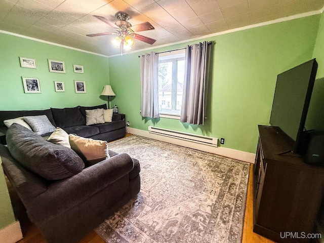 living room with ceiling fan, a baseboard radiator, hardwood / wood-style flooring, and ornamental molding