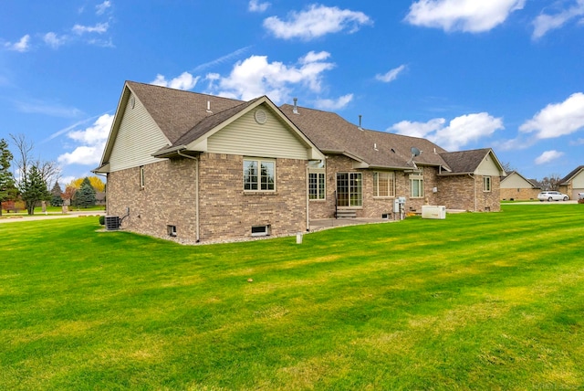 back of house featuring a lawn, a patio area, and central AC unit