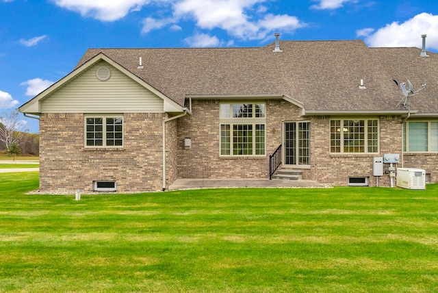 rear view of property with a lawn