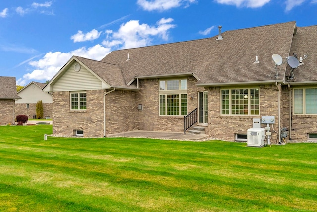 rear view of house with a yard and a patio