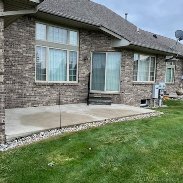 rear view of house featuring a lawn and a patio area