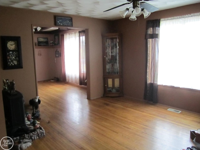 interior space with light wood-type flooring, plenty of natural light, and ceiling fan