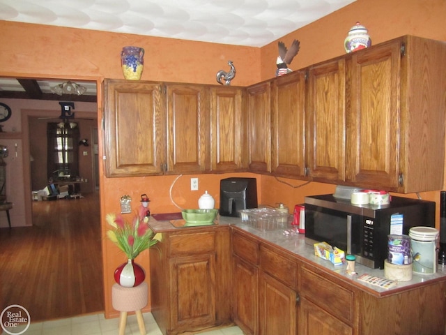 kitchen featuring light hardwood / wood-style flooring and tile counters