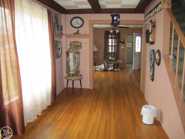 corridor with hardwood / wood-style flooring