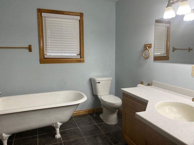 bathroom with tile patterned floors, vanity, toilet, and a tub