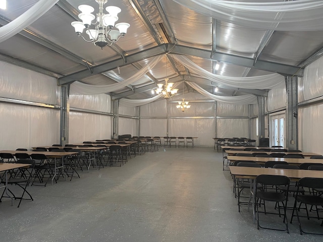 dining room featuring a chandelier and high vaulted ceiling