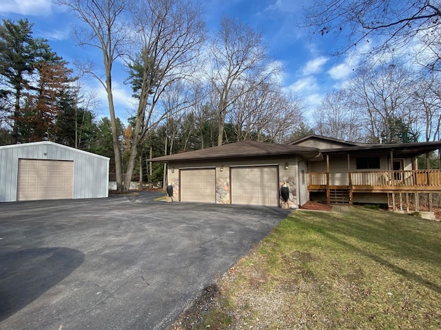 view of property exterior featuring a lawn, a garage, and a wooden deck