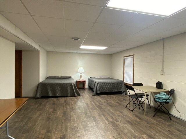 2250 Dryer Rd, Standish, MI 48658 - bedroom featuring wood finished floors and concrete block wall