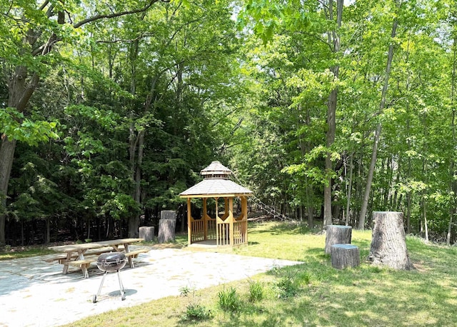 2250 Dryer Rd, Standish, MI 48658 - view of grassy yard featuring a gazebo, a patio, and a view of trees