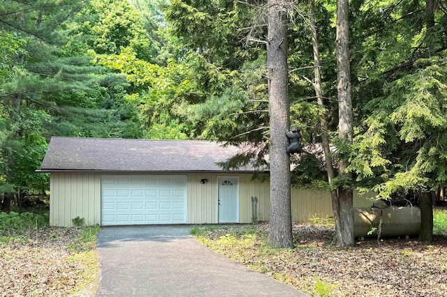 2250 Dryer Rd, Standish, MI 48658 - view of front facade featuring asphalt driveway, a shingled roof, and a wooded view