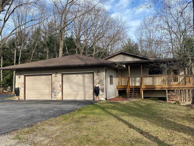 view of front of house featuring a garage, a wooden deck, and a front lawn