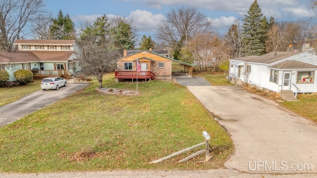 view of front of house with a deck and a front lawn