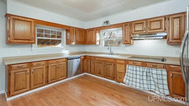 kitchen with stainless steel appliances, light hardwood / wood-style flooring, crown molding, and sink