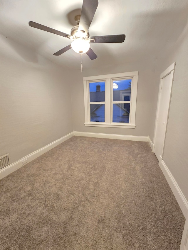 empty room with carpet floors and ceiling fan