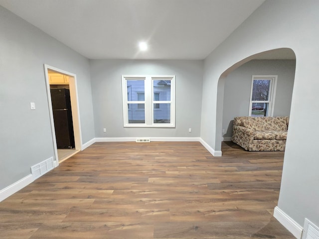 unfurnished room with hardwood / wood-style floors