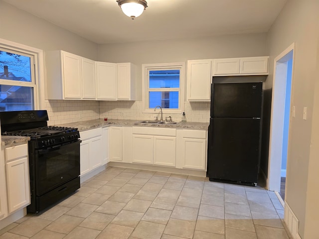 kitchen with white cabinets, sink, and black appliances