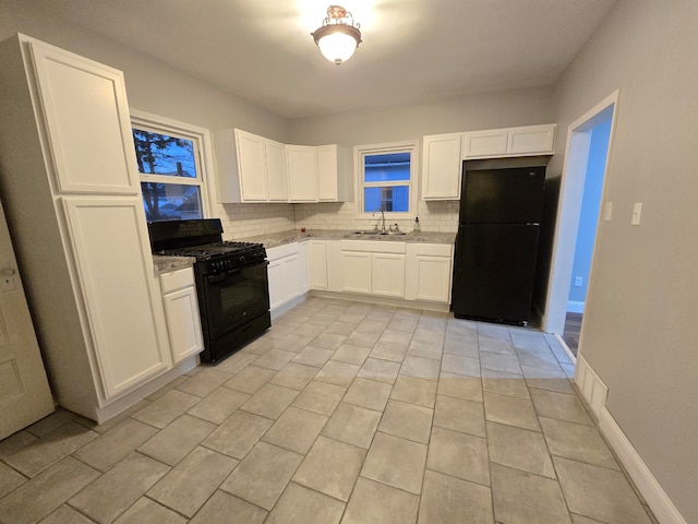 kitchen with decorative backsplash, sink, black appliances, white cabinetry, and light tile patterned flooring