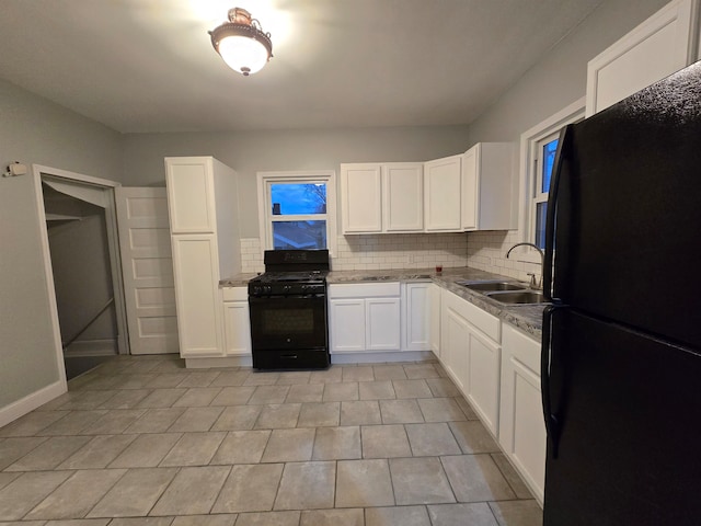 kitchen featuring decorative backsplash, sink, black appliances, light tile patterned floors, and white cabinets