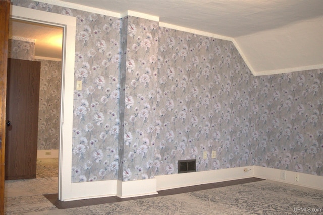 empty room with a textured ceiling and ornamental molding