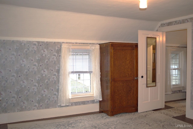 spare room with lofted ceiling