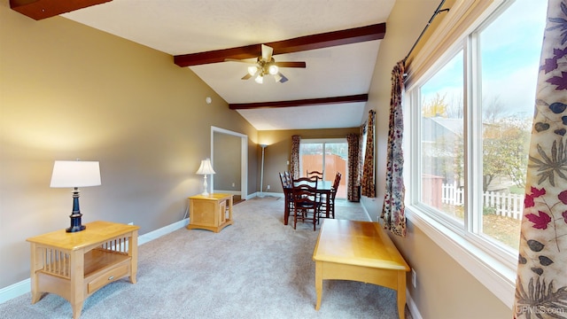 interior space featuring light carpet, vaulted ceiling with beams, and ceiling fan