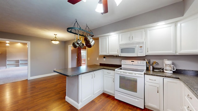 kitchen with kitchen peninsula, white appliances, white cabinets, and dark wood-type flooring